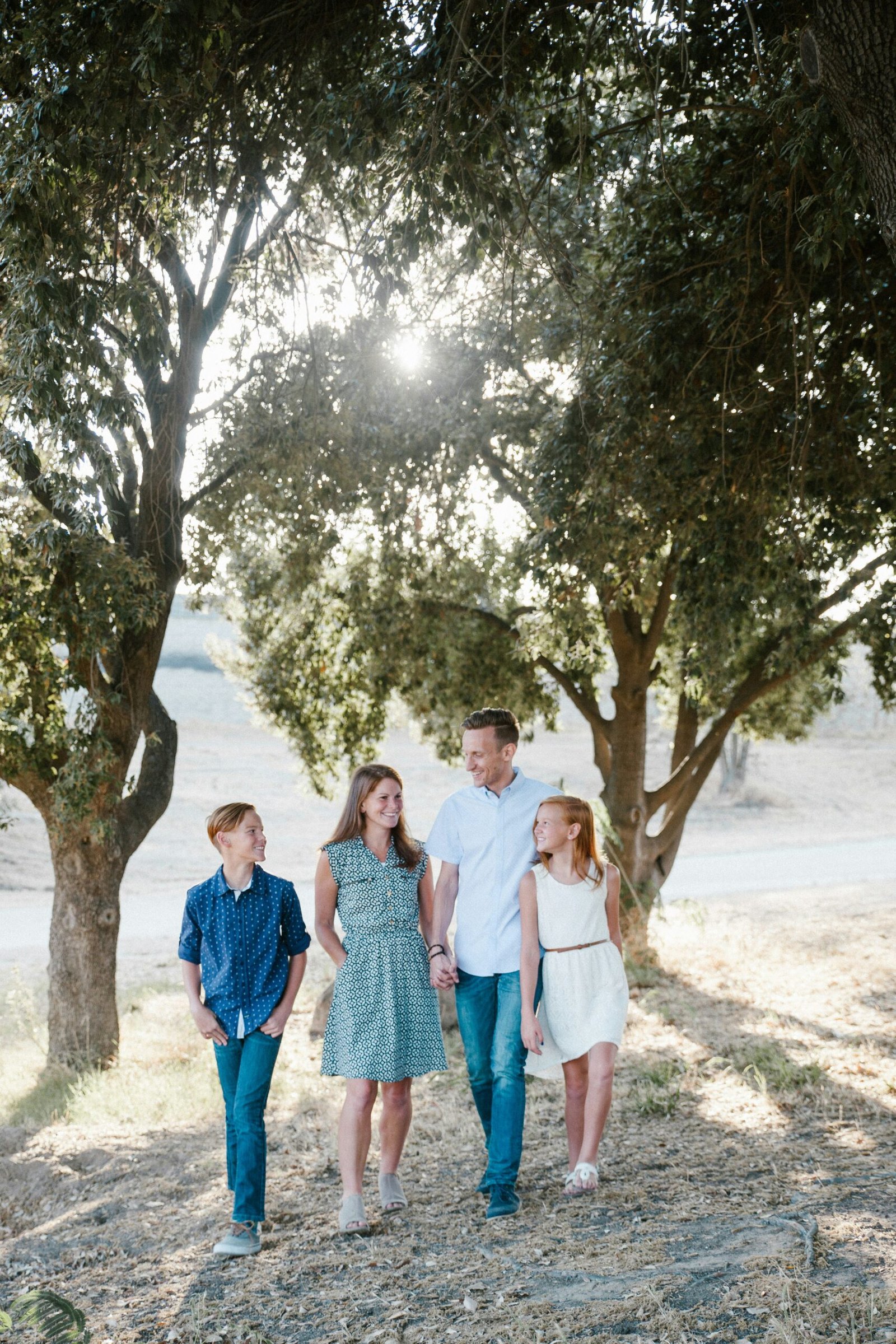 A family walking together under trees