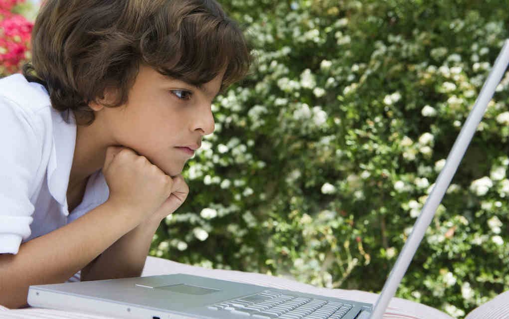 Online safety for kids – Mykidstime Boy on laptop for online safety for kids - Mykidstime