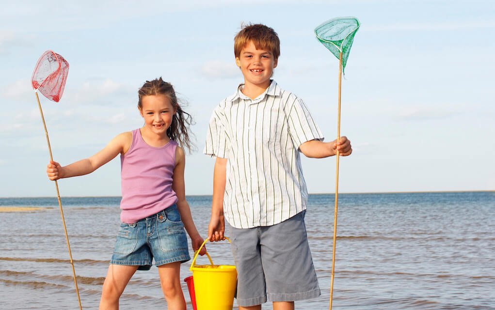 Girl and boy fishing at the beach