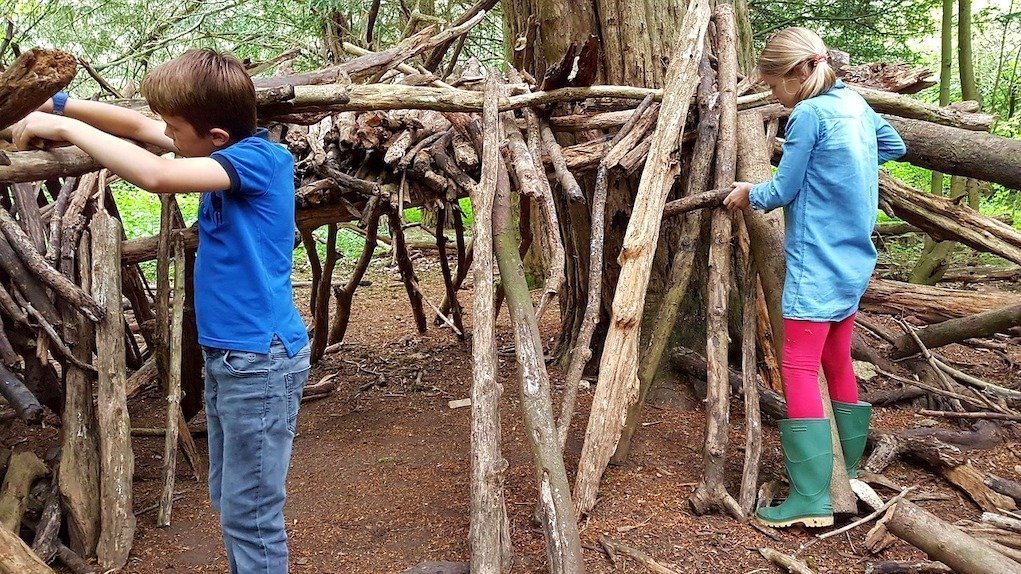 children building an outdoor fort or den eco friendly activities to amuse the kids